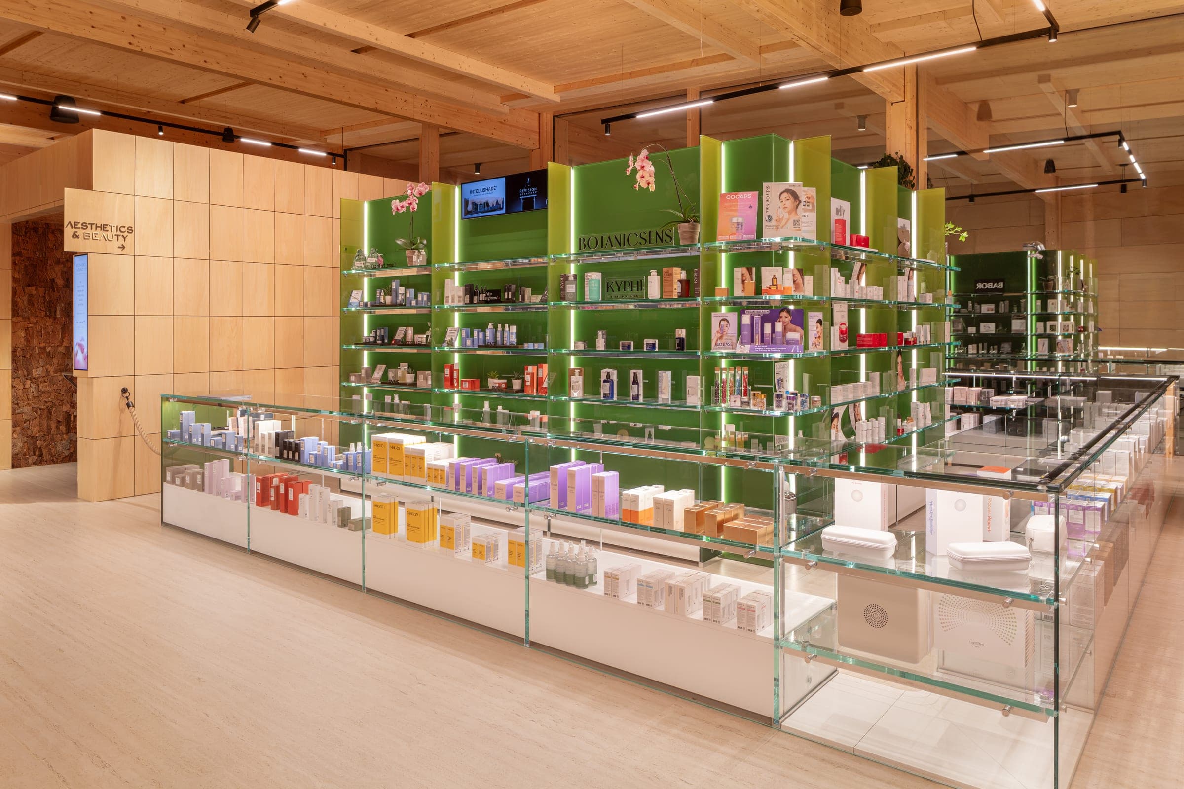 The Aesthetics and Beauty retail floor — lit product cases and skincare shelving
